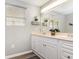 Bright bathroom features a large mirror and double sink vanity, complemented by stylish decor at 301 58Th Ave. N, North Myrtle Beach, SC 29582
