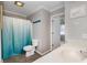 This bathroom features a shower with blue curtain and vanity at 301 58Th Ave. N, North Myrtle Beach, SC 29582