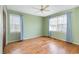 Bright bedroom with wood floor and natural light from windows and fan at 301 58Th Ave. N, North Myrtle Beach, SC 29582