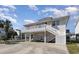 Inviting two-story home with a balcony and staircase leading to the ground level at 301 58Th Ave. N, North Myrtle Beach, SC 29582