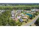 This aerial view highlights a community with homes, trees, and a pond at 320 Cog Hill Ct., Murrells Inlet, SC 29576