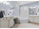 A luxurious Primary bathroom with dual sinks, a soaking tub, and ample counter space at 320 Cog Hill Ct., Murrells Inlet, SC 29576
