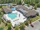 This aerial shot showcases a community pool with ample lounge seating and a clubhouse at 320 Cog Hill Ct., Murrells Inlet, SC 29576