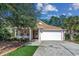 Charming single-story home featuring a two-car garage, front porch and well-manicured lawn at 320 Cog Hill Ct., Murrells Inlet, SC 29576