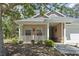 Front exterior of a home featuring a small porch with a landscaped yard at 320 Cog Hill Ct., Murrells Inlet, SC 29576