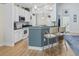 A well-lit kitchen showcases white cabinets, modern appliances, and a stylish breakfast bar with seating at 320 Cog Hill Ct., Murrells Inlet, SC 29576