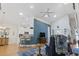 Open-concept living room with hardwood floors, blue accent wall, and view to kitchen at 320 Cog Hill Ct., Murrells Inlet, SC 29576