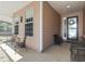 Spacious front porch with tile flooring and comfortable seating areas at 320 Cog Hill Ct., Murrells Inlet, SC 29576