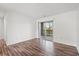 Bright bedroom features hardwood floors, white walls, and sliding glass doors to balcony at 380 Myrtle Greens Dr. # D, Conway, SC 29526