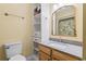 Bathroom with vanity, stylish mirror, storage shelves, and a toilet at 404 75Th Ave. N # E, Myrtle Beach, SC 29572