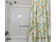 Bathtub with showerhead and tropical-patterned shower curtain at 404 75Th Ave. N # E, Myrtle Beach, SC 29572