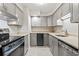 Well-lit kitchen features stainless steel appliances, modern cabinets and mosaic tile backsplash at 404 75Th Ave. N # E, Myrtle Beach, SC 29572