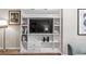 Close up of built-in shelving unit with a TV and modern decor at 404 75Th Ave. N # E, Myrtle Beach, SC 29572