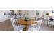 Dining area with a wooden table and white chairs next to an open-concept kitchen at 417 Flank St., Myrtle Beach, SC 29588