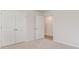 Bedroom boasts neutral walls and carpet flooring, along with closet doors and an open door at 425 Flank St., Myrtle Beach, SC 29588