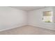 A bright bedroom features neutral carpeting and a window with blinds for ample natural light at 425 Flank St., Myrtle Beach, SC 29588