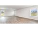 Bright and airy living area featuring wood-look flooring, natural light, and a view to the outdoors through the glass door at 425 Flank St., Myrtle Beach, SC 29588