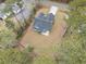 Aerial view of a home showcasing its roof, landscaping, and driveway surrounded by mature trees at 480 N Boundaryline Dr. Nw, Calabash, NC 28467