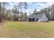 Spacious backyard with lush green lawn, screen porch and patio area, perfect for outdoor enjoyment at 480 N Boundaryline Dr. Nw, Calabash, NC 28467