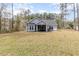 A well-maintained backyard featuring a screen porch with outdoor seating and a manicured lawn at 480 N Boundaryline Dr. Nw, Calabash, NC 28467