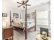 Bedroom showcasing four-poster bed, ceiling fan, wood flooring, and a window at 480 N Boundaryline Dr. Nw, Calabash, NC 28467
