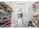 View of the closet showing shoe racks and clothing, leading into the main bedroom at 480 N Boundaryline Dr. Nw, Calabash, NC 28467