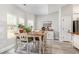 Bright dining area features wood table, white chairs, wood floors, and natural light at 480 N Boundaryline Dr. Nw, Calabash, NC 28467