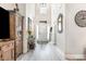 Bright entryway with tall ceilings, light gray wood flooring, and decorative accents enhancing its appeal at 480 N Boundaryline Dr. Nw, Calabash, NC 28467