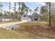 Charming home featuring a two-car garage, stone accents, and complemented by a beautifully landscaped front yard at 480 N Boundaryline Dr. Nw, Calabash, NC 28467