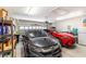 Garage featuring two parked cars, storage shelves, and roll-up door at 480 N Boundaryline Dr. Nw, Calabash, NC 28467