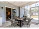 Screened-in porch showcasing wicker chairs, fire pit table, and string lights at 480 N Boundaryline Dr. Nw, Calabash, NC 28467