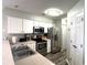 Well-lit kitchen with stainless steel appliances, ample counter space, and white cabinets at 524 Pinehurst Ln. # 19D, Pawleys Island, SC 29585