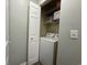 A laundry closet featuring a full size washing machine, storage shelves, and a light switch at 524 Pinehurst Ln. # 19D, Pawleys Island, SC 29585