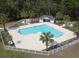Resort-style pool and jacuzzi with white picket fence, palm trees, and lounge chairs at 524 Pinehurst Ln. # 19D, Pawleys Island, SC 29585