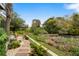 A backyard featuring a scenic view of a pond with landscaping, stone pathway, and outdoor seating at 5361 Ocean Village Dr., Myrtle Beach, SC 29577