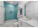 Modern bathroom showcasing blue tiled shower/tub, white vanity, a sink and beach-themed decorations at 5361 Ocean Village Dr., Myrtle Beach, SC 29577