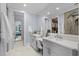 Bathroom with double vanity, large mirror, and doorway to bedroom at 5361 Ocean Village Dr., Myrtle Beach, SC 29577