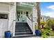 Charming coastal home featuring a welcoming front porch with a light blue accent door and stairway entrance at 5361 Ocean Village Dr., Myrtle Beach, SC 29577