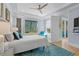 Calm bedroom with large window, hardwood flooring, light walls, and ceiling fan at 5361 Ocean Village Dr., Myrtle Beach, SC 29577