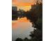 Picturesque marsh view with building reflections and orange sunset backdrop at 5361 Ocean Village Dr., Myrtle Beach, SC 29577