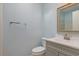 This light blue bathroom features a modern sink, toilet, and chrome towel rack at 5525 Springs Ave., Myrtle Beach, SC 29577