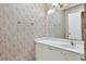 Bathroom featuring decorative wallpaper, vanity with a white countertop and ample storage at 5525 Springs Ave., Myrtle Beach, SC 29577