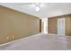 This bedroom has carpet flooring, a ceiling fan, and an entrance to the hallway at 5525 Springs Ave., Myrtle Beach, SC 29577