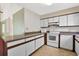 Efficient kitchen design with white cabinetry, updated appliances, and functional layout at 5525 Springs Ave., Myrtle Beach, SC 29577
