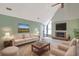 Cozy living room features a fireplace, vaulted ceiling, and comfortable seating arrangement at 5525 Springs Ave., Myrtle Beach, SC 29577