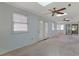 Bright living area featuring a skylight, ceiling fans, carpet flooring and multiple windows for natural light at 5525 Springs Ave., Myrtle Beach, SC 29577