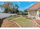 Landscaped backyard with brick-lined garden beds, a white pergola, a fenced in pool and covered patio area at 5628 Marion Circle, Myrtle Beach, SC 29577