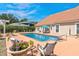 Backyard pool area surrounded by lush landscaping, patio seating, and serene ambiance at 5628 Marion Circle, Myrtle Beach, SC 29577