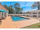 Backyard pool and white pergola with furniture, seating, and surrounding green landscape at 5628 Marion Circle, Myrtle Beach, SC 29577