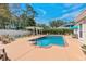 Refreshing pool area features ample seating, privacy fence, and pergola for outdoor relaxation at 5628 Marion Circle, Myrtle Beach, SC 29577